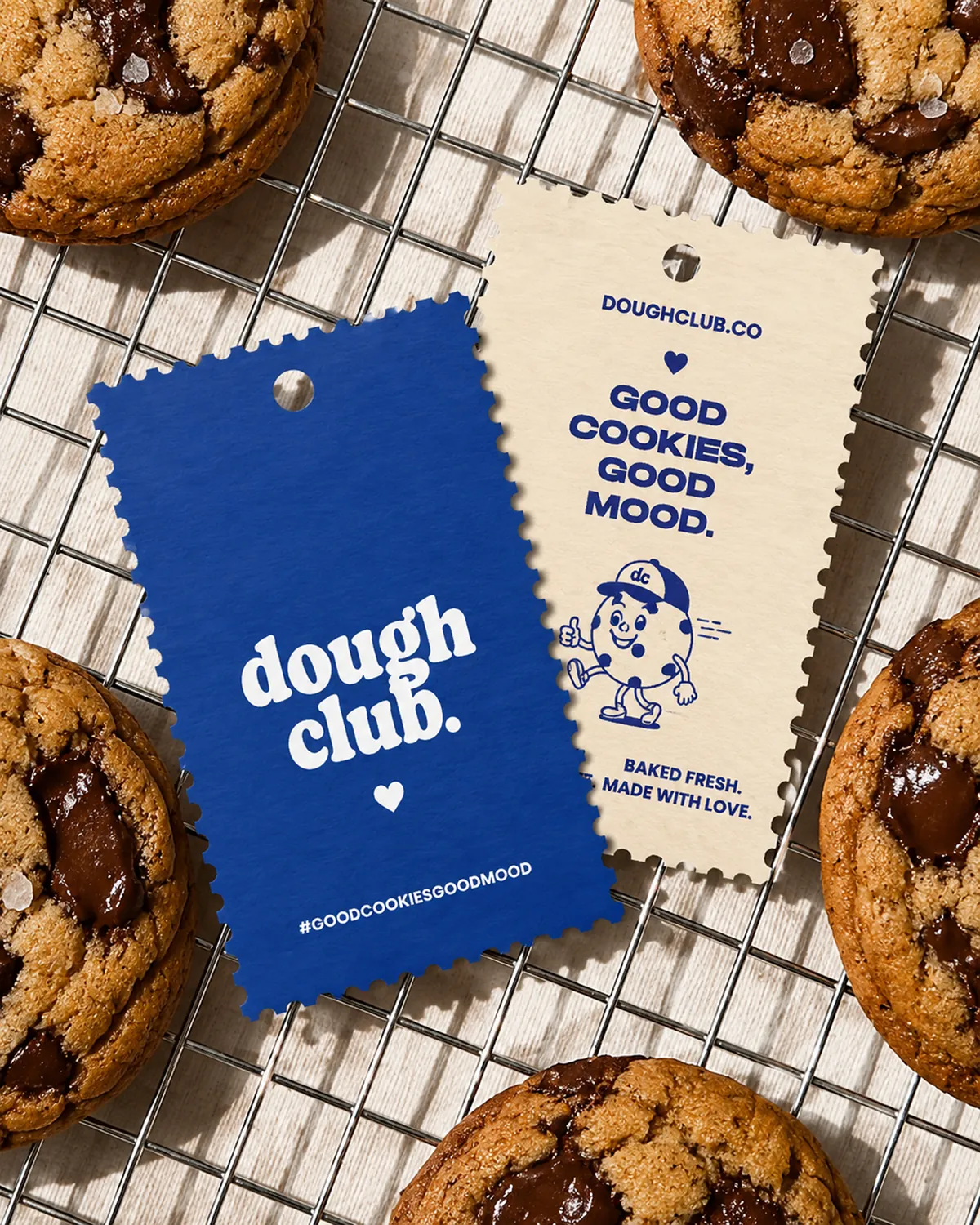 Dough Club hang tags on a cooling rack of cookies