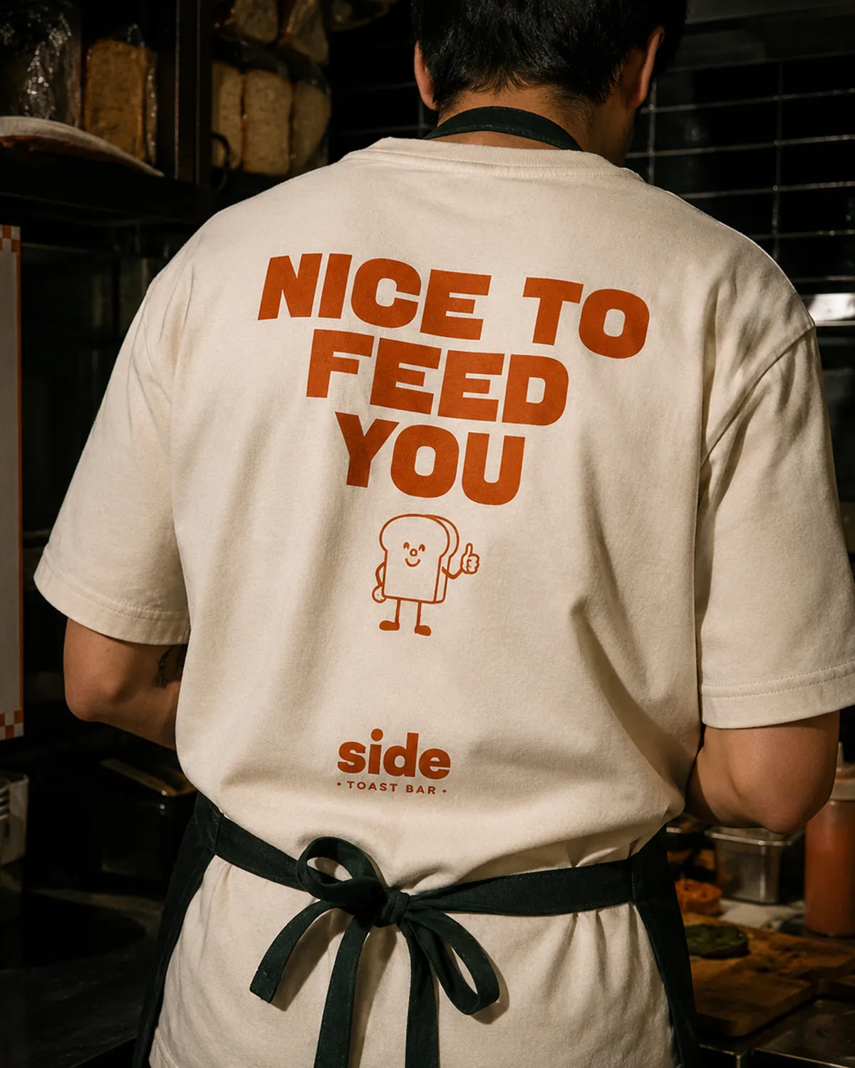 Staff T-shirt printed with Nice to feed you and the toast mascot